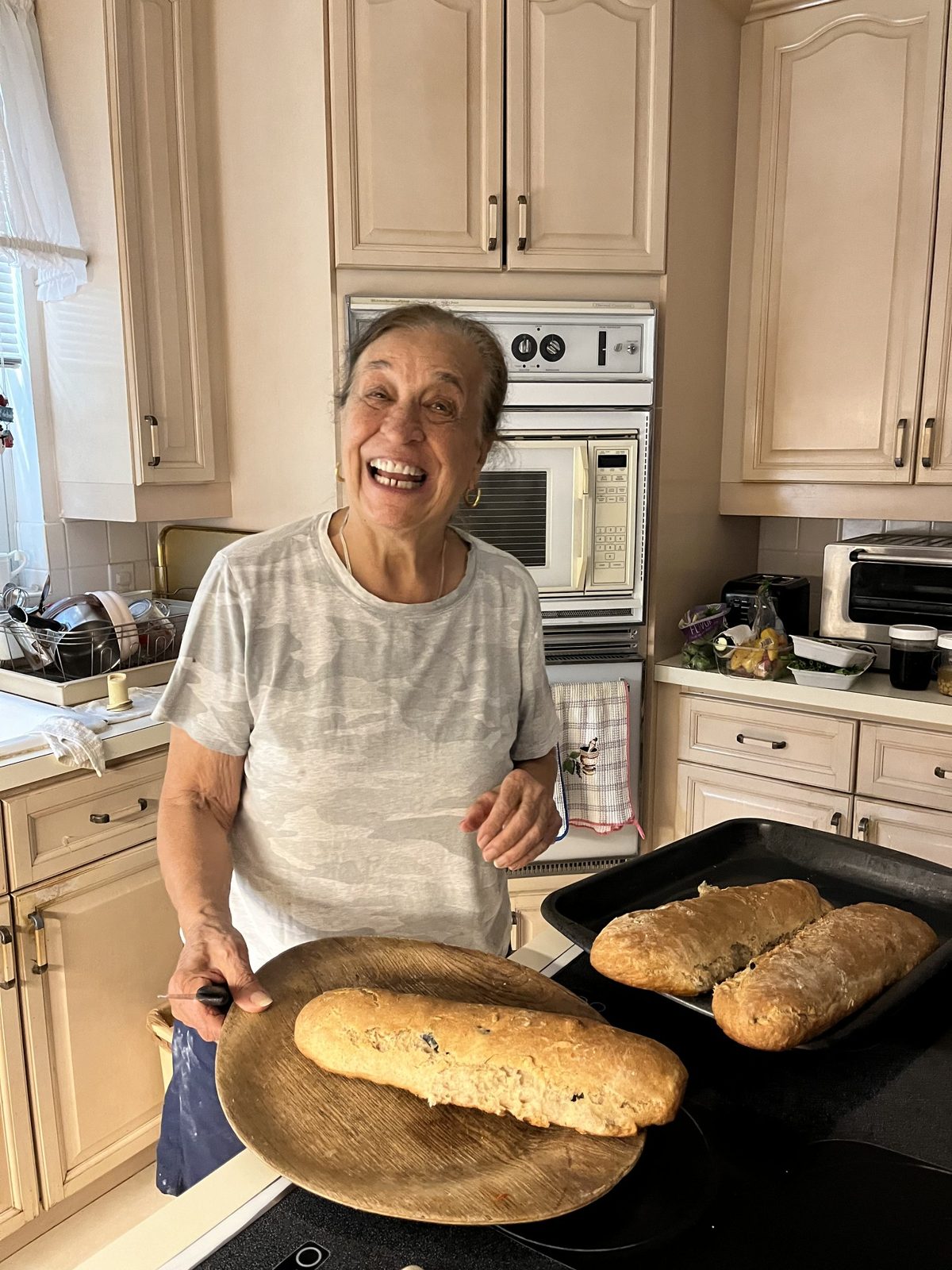 Nonna Do laughing with her fresh olive bread